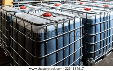 large plastic containers with liquids in production. Barrels for the chemical industry. White plastic containers. Chemical industry Royalty-Free Stock Photo #2294184617