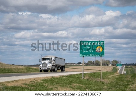 Nebraska, the good life, home of Arbor Day - roadside welcome sign at state border with Kansas, spring scenery