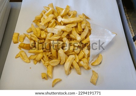 Portion of British chips at fish and chip shop, UK Royalty-Free Stock Photo #2294191771