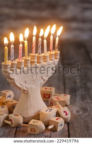 Jewish holiday hannukah symbols - menorah and wooden dreidels. Copy space background.
