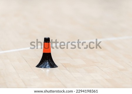 Training cones on hardwood court floor. Basketball, futsal, handball and volleyball practice. Game equipment Horizontal sport theme poster, greeting cards, headers, website and app