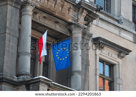 The flag of Poland and the European Union hangs on the building