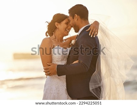 Ill stand by your side in the good and the bad. Shot of a young couple on the beach on their wedding day. Royalty-Free Stock Photo #2294225051