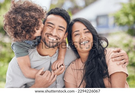 A happy family is the ultimate goal in life. Portrait of a happy family relaxing together outdoors.