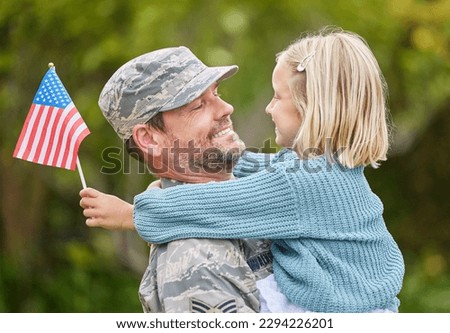 Families should celebrate each members unique identity. Shot of a father returning from the army hugging his daughter outside.
