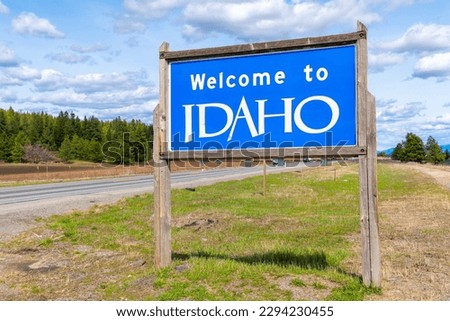 A roadside welcome to Idaho sign coming from Spokane Washington and entering North Idaho at Post Falls, Idaho, USA	