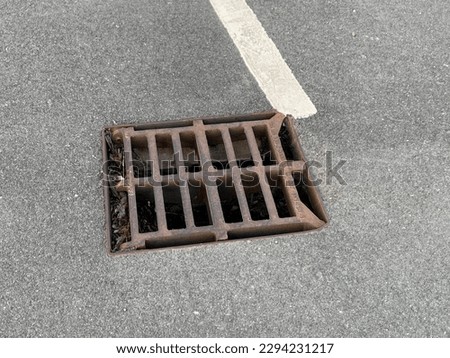 Picture of a storm drain in a school car park