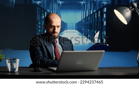 IT infrastructure specialist working in render farm, creating online networking system for digitalization. Network engineer using hardware and web storage in modern data center. Royalty-Free Stock Photo #2294237465