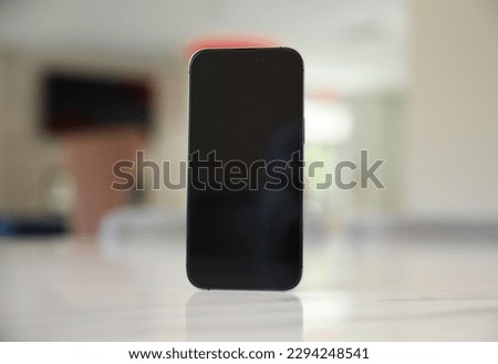 An empty black phone screen mock-up symbolizes the potential for disconnection and addiction to technology, highlighting the need for balance and mindfulness in our relationship with digital devices