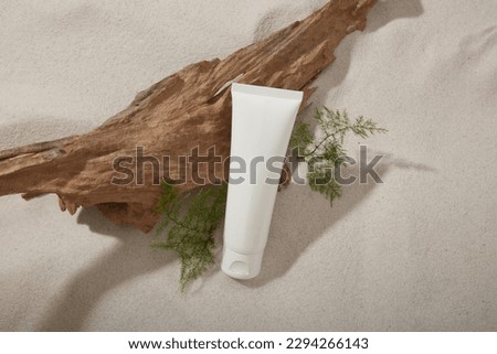 Mockup scene for cosmetic with white plastic bottle unbranded on sand texture background with dried twig and green leaves. Natural concept Royalty-Free Stock Photo #2294266143