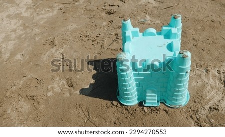 a plastic mold for a sand castle in summer holidays, on a beach