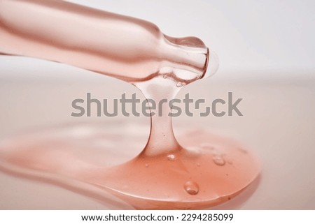 Pipette with a viscous pink cosmetic close-up. Royalty-Free Stock Photo #2294285099