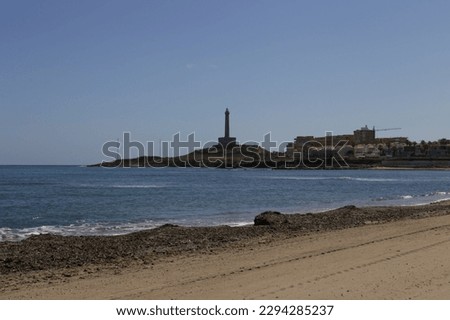 Levante Beach in Cabo de Palos fishing village. Lighthouse in the background