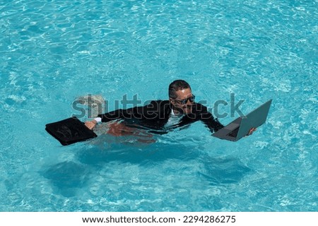 Businessman in suit with laptop in swimming pool. Crazy business man on summer vacation. Excited businessman in wet suit in swim pool. Funny business man, crazy comic business concept. Remote working. Royalty-Free Stock Photo #2294286275