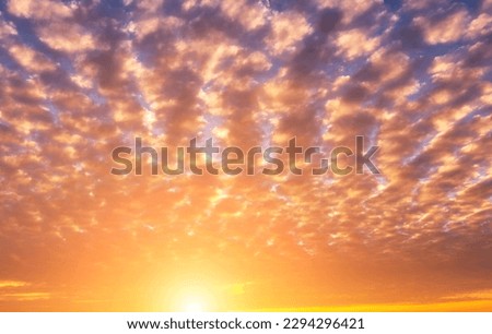 The rays of the sun breaking through the dramatic clouds in the evening or in the morning in the sunset or dawn sky. The concept of faith, hope for the best or good weather.