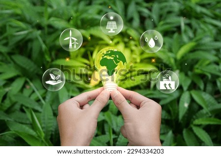 Renewable Energy. Hand holding light bulb with icons energy sources for renewable, sustainable development. green energy concept energy sources sustainable. Ecology Elements.Environmental protection. Royalty-Free Stock Photo #2294334203