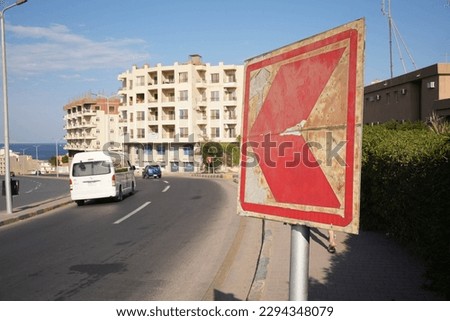 A road turn with a big red sign in Egypt