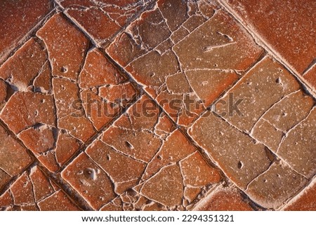 Old stone tiles on the floor of the castle, cracked terracotta tiles, idea for a background or screensaver, destruction and use of natural materials