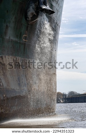 ship in the port of hamburg empties ballast water tank Royalty-Free Stock Photo #2294351323