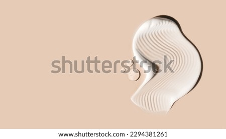 cosmetic smears of creamy texture on beige background