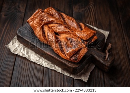 Lush bun with cinnamon and jam on brown boards. For decoration of bakery sales outlets. Bakery products. Fresh bakery. Royalty-Free Stock Photo #2294383213