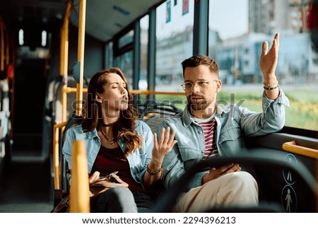 Young couple having a quarrel while commuting by city bus.  Royalty-Free Stock Photo #2294396213