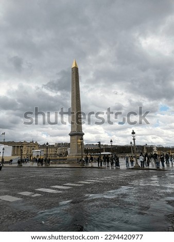 Famous parisien square Place de la Concorde with monument during cloudy day.