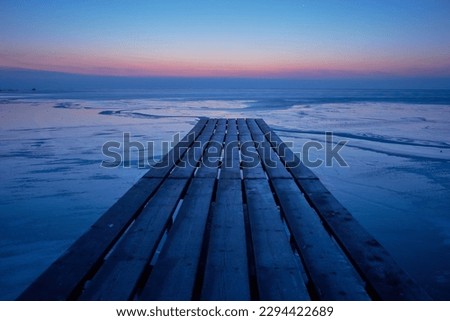 wooden pontoon with boats before sunrise in the Danube delta 01 Royalty-Free Stock Photo #2294422689