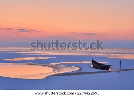 sunrise on the lake with wooden boats in winter 6