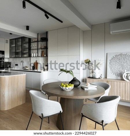 Contemporary design of dining room interior with round table, gray chairs, wooden floor, decorations, flowers in vase, paintings and elegant personal accessories. Stylish home decor. Template.
