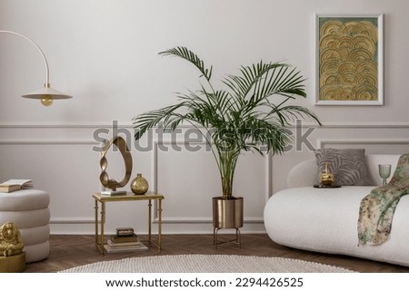 Warm composition of living room interior with boucle armchair, sofa, plant in gold pot, green pillows, round rug, stylish coffee table, wall with stucco and personal accessories. Home decor. Template. Royalty-Free Stock Photo #2294426525