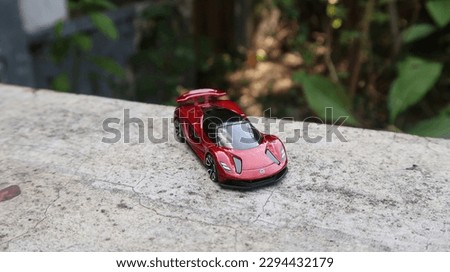 Picture of a toy red vehicle that closely matches the real thing