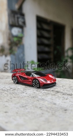 Picture of a toy red vehicle that closely matches the real thing