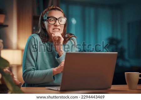 Stressed panicked woman working with her laptop at home, she is having computer problems: system failure and virus infection concept Royalty-Free Stock Photo #2294443469