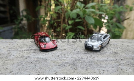 pictures of red toy cars and very reasonable-looking police cars