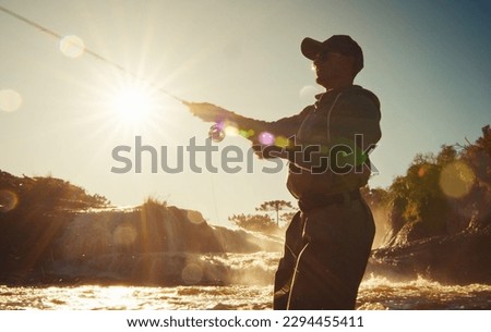 Fly fishing. Fisherman in waders fishing on the rapid river Royalty-Free Stock Photo #2294455411