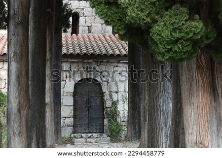 An ancient stone building with an iron door