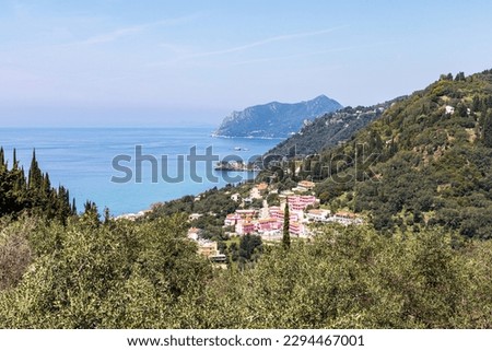  A beautiful landscape of the coast of the island of Corfu in the Ionian Sea of the Mediterranean in Greece. Pure blue clear water washes over the shores of the Greek island.