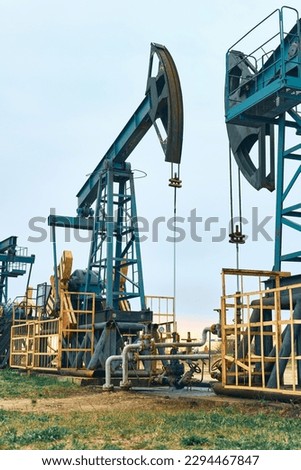 Prairie Oil Pump Jacks. Crude oil is a major economic driver. Themes in the image include geology, engineering, pump, rig, well, gas, coal, methane, natural gas, oil, natural resources, and energy.
