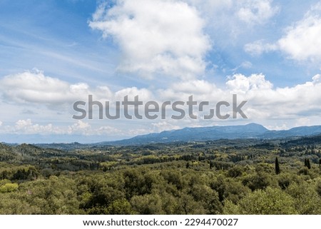 A beautiful landscape of the island of Corfu in the Ionian Sea in Greece. Mountains with plenty of green vegetation. Thick clouds over the island.