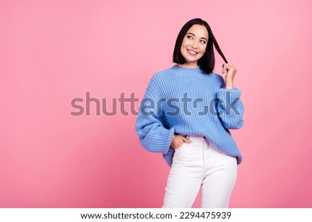 Photo of minded creative cute girl hand play hair look empty space isolated on pink color background