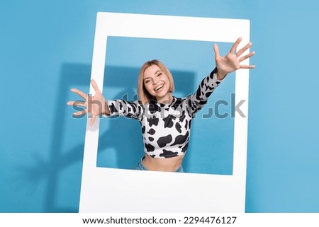 Portrait of funky cheerful person raise opened arms through paper album card invite welcome you isolated on blue color background