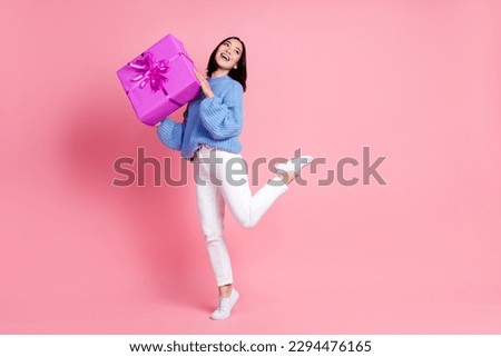 Photo of pleasant grateful woman straight hairdo dressed knit pullover hold gift look empty space isolated on pink color background Royalty-Free Stock Photo #2294476165