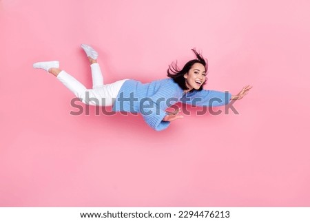 Full size profile photo of cheerful peaceful girl flying levitate isolated on pink color background