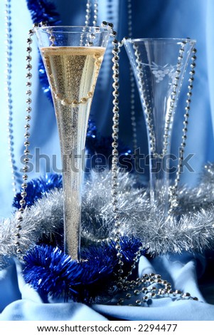 Glass of champagne on a silver-blue background
