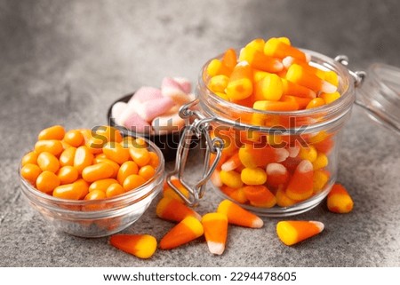 Halloween candy on a black background. coffee corn and sazar skull.Halloween holiday background with jack o lantern pumpkin, candy corn and decorations.Top view.Flat lay. Place for text.