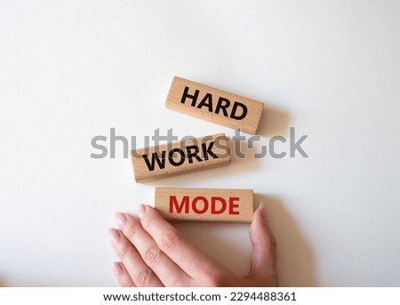 Hard Work Mode symbol. Concept word Hard Work Mode on wooden blocks. Businessman hand. Beautiful white background. Business and Hard Work Mode concept. Copy space