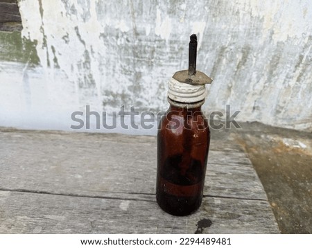 Traditional bottle lamp.  The lamp is made from used glass bottles and is given a wick and kerosene