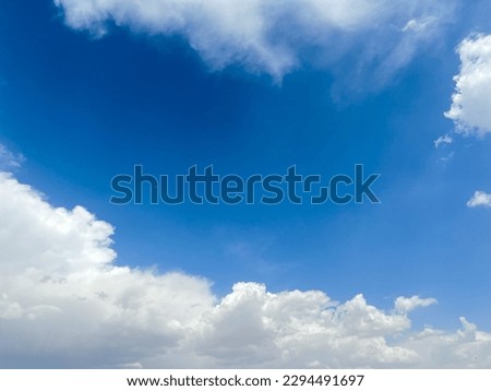 Clouds in the sky. White cirrus clouds on a blue sky. Clouds in motion. Summer blue sky. Clouds in perspective. Going to the horizon