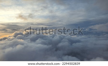 a picture of clouds view at dawn taken from airplane cabin window